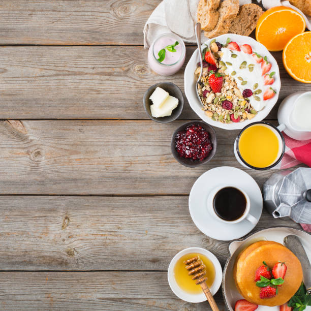 istock Breakfast table with waffles, granola, yogurt, pancakes, juice, coffee 960269200