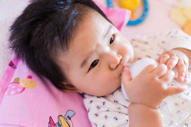 istock Baby drinking milk close-up 960273344