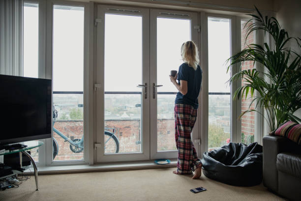 istock Young Adult Looking Out the Window 960273666
