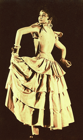 Vintage sepia toned photo of a young spanish flamenco dancer from the sixties of the twentieth century.