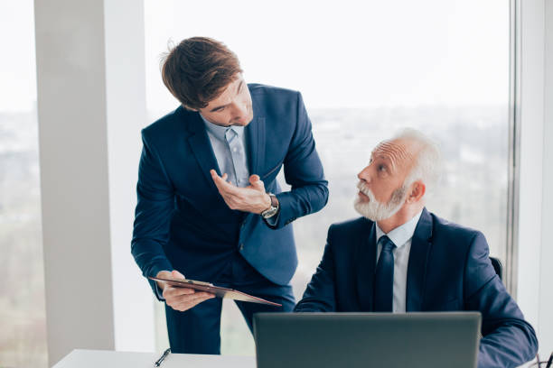 istock Coworkers discussing paperwork in office 960278154