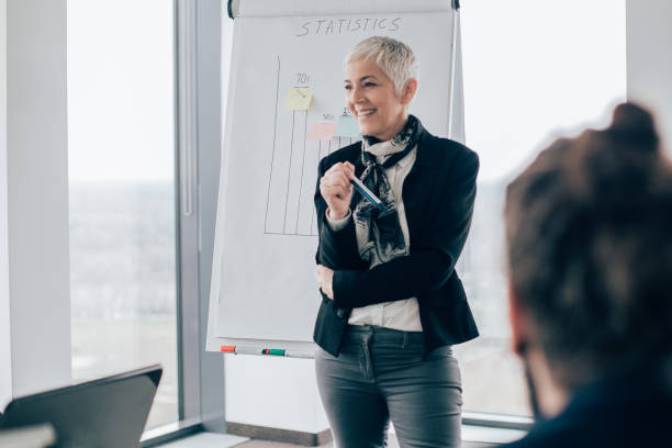 istock Senior woman discussing statistics 960282058