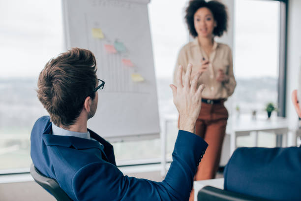 istock Business man raising hand at presentation 960282176