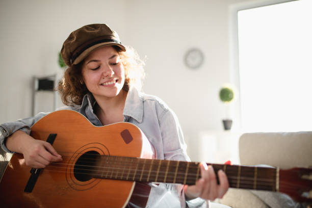 istock Woman playing guitar and enjoying 960282244