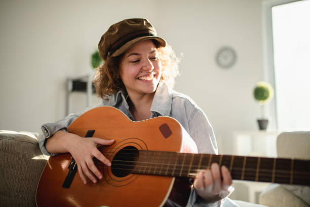 istock Woman playing guitar and enjoying 960282386