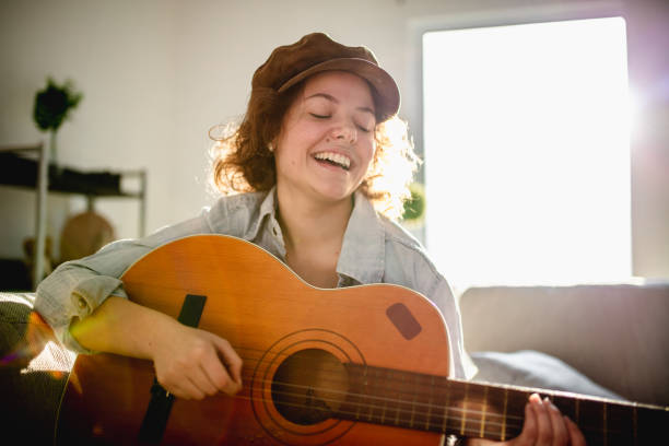 istock Woman playing guitar and enjoying 960282656