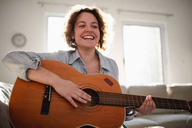 istock Woman playing guitar and enjoying 960282764
