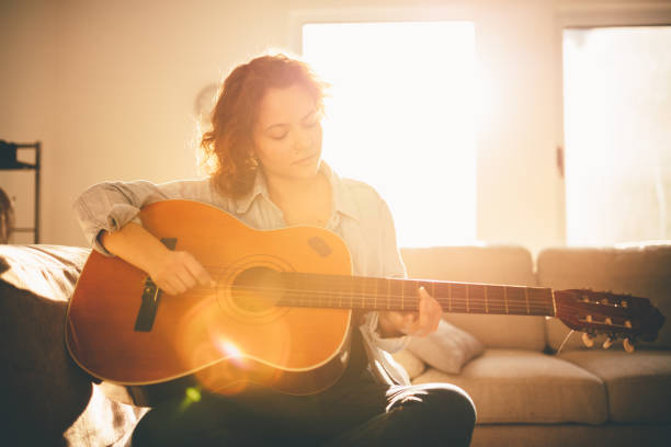 istock Woman playing guitar and enjoying 960285046