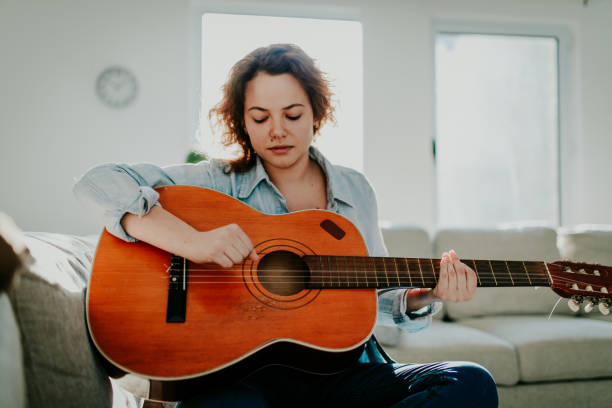 istock Woman playing guitar and enjoying 960285210