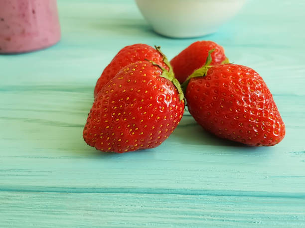 strawberry in on a blue wooden background