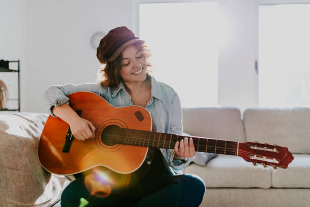 istock Woman playing guitar and enjoying 960285368