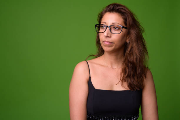 istock Beautiful woman against green background 960286338