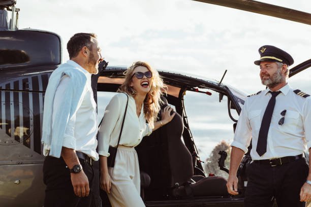 istock Couple alight from a private helicopter 960286798