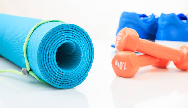 istock Yoga mat and dumbbells on white background 960289550