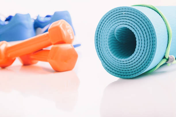 istock Yoga mat and dumbbells on white background 960289552