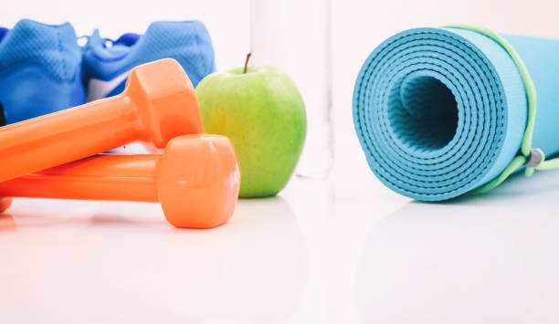 istock Yoga mat and dumbbells on white background 960289588