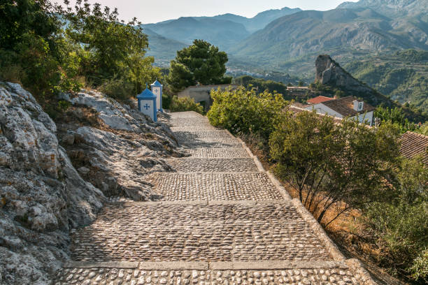istock Stony road in the mountains. Plants, sun, mountains. 960289794