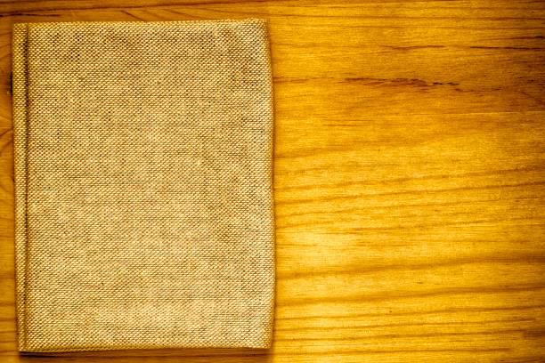 istock Ultra yellow Postcard sample, linen fabric surface on wooden table with free copyspace for greeting text, for mock-up or designer use, book cover sample 960290072