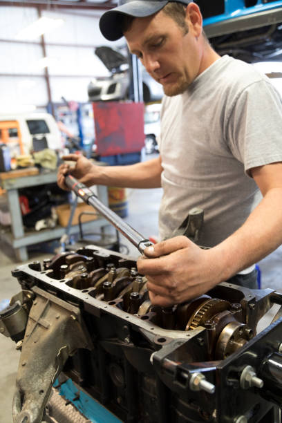istock Auto Repair Garage with Mechanic, Torque Crankshaft Main Bearings 960294814