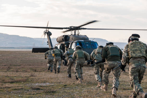 Ankara, Turkey - May 16, 2017: Turkish Gendarmerie exercise and demonstration in a field near Ankara  in Turkey.Turkish Gendarmerie soldiers boarding a Sikorsky UH-60 Black Hawk military helicopter while some other soldiers providing covering fire.
