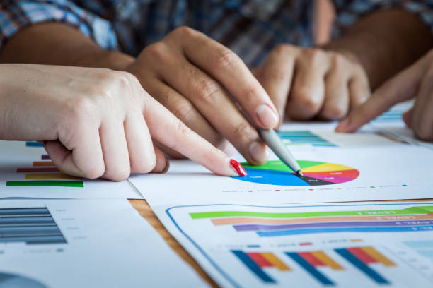 istock Business team work brainstroming meeting process. Business people discussing the charts and graphs showing the results of their successful teamwork. 960295604
