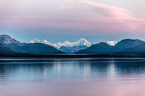 Cruising through Alaska's Glacier Bay National Park at dawn, summer.