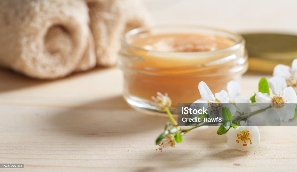 Moisturizing cream and almond blossoms on wooden background Spa Stock Photo