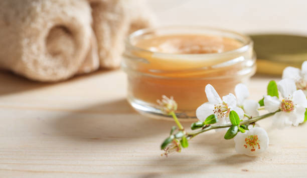 Moisturizing cream and almond blossoms on wooden background Moisturizing cream and almond blossoms on wooden background mediterranean culture stock pictures, royalty-free photos & images