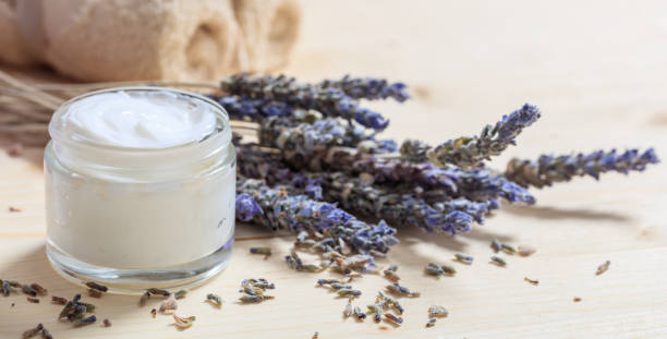 Moisturizing cream and lavender on wooden background Moisturizing cream and lavender on wooden background ointment photos stock pictures, royalty-free photos & images