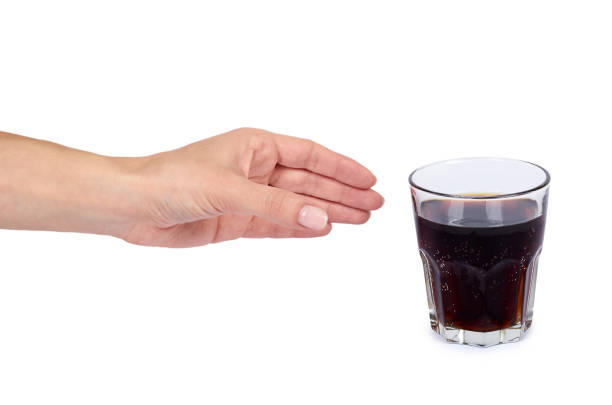 istock Cola drink in glass with hand isolated on white background 960306642