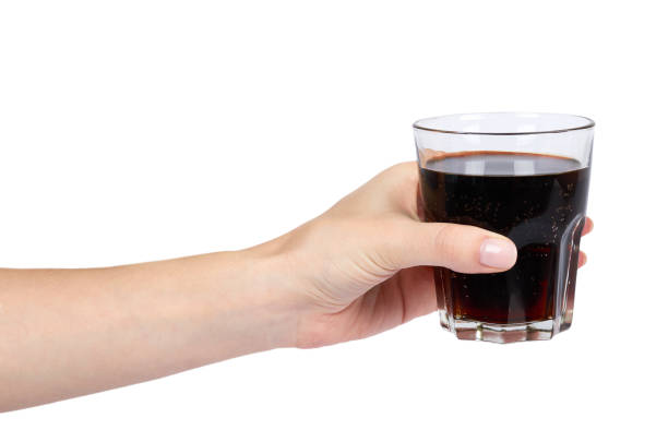istock Cola drink in glass with hand isolated on white background 960306644