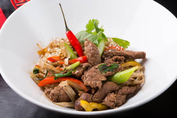 Thai spicy noodles dish with meat Thai spicy noodles dish with meat and vegetables beef pad stock pictures, royalty-free photos & images