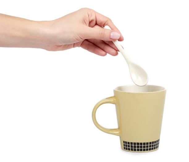 istock Porcalain brown tea cup with hand isolated on white background 960307972