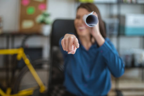 Having fun with plans in the office Gorgeous looking businesswoman, sitting at the office desk during work hours. office fun business adhesive note stock pictures, royalty-free photos & images