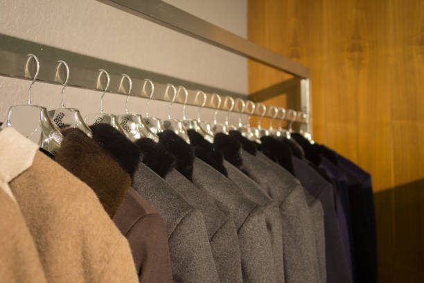 istock Men coats on hangers in the shop. 960310962