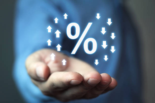 istock Man holding percent sign with up and down arrows. 960313626