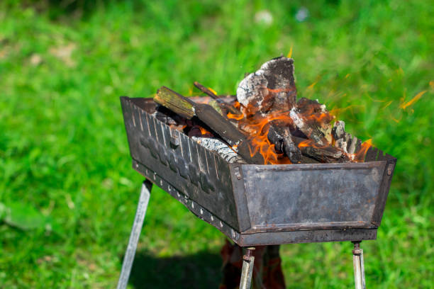 istock barbecue grill with burning coals on nature, close up 960316622