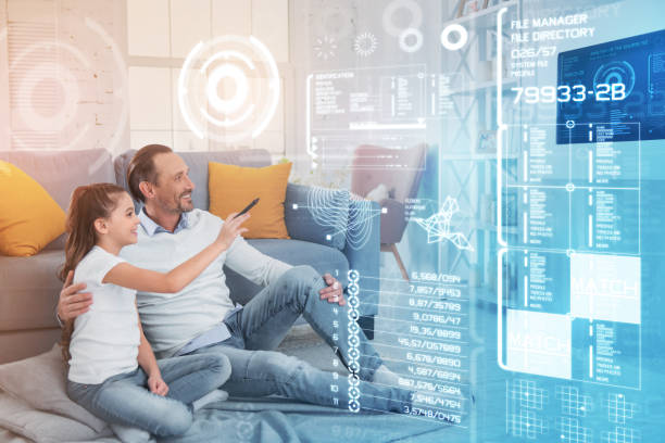 istock Happy girl using a smart house system while sitting with her father 960317196