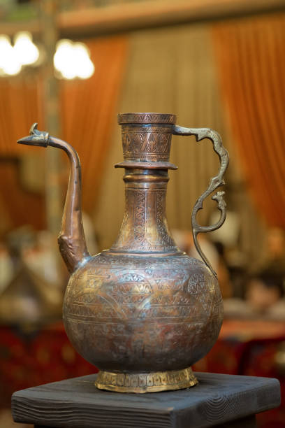 istock Old copper water ewer over yellow background 960318304