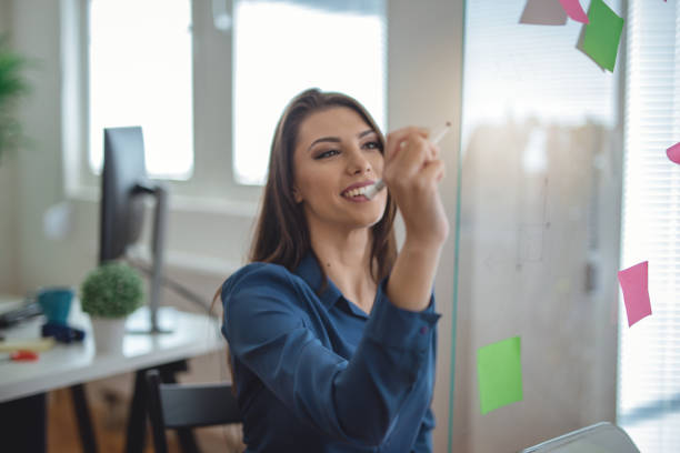 istock Businesswoman writing on glass 960320630