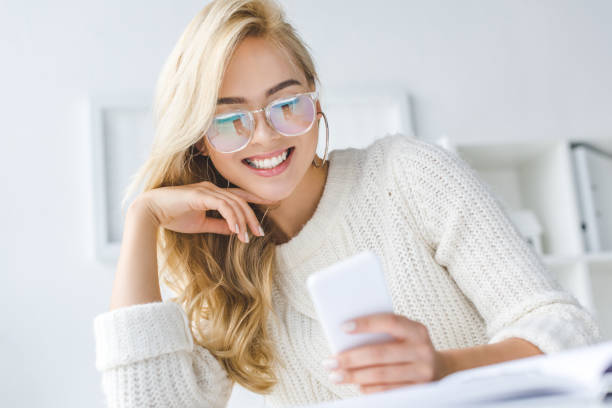 istock businesswoman in eyeglasses using smartphone 960324584