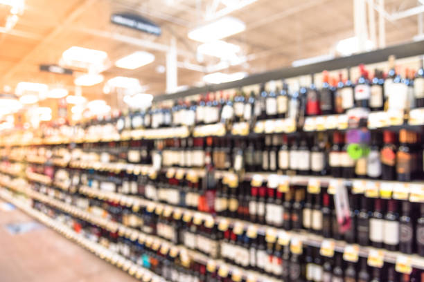 istock Abstract blurred wine shelves with price tags on display in supermarket 960326244