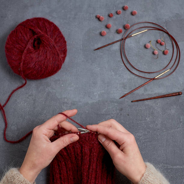 istock Close-up of hands knitting. 960327404