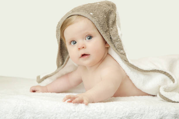 istock Adorable baby covered with bath towel, studio shot 960333456