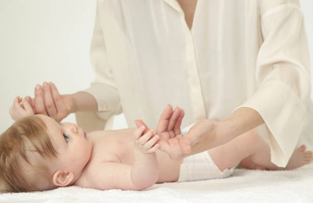 istock Mother massaging baby hands and doing exercise after bath 960333680