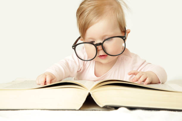 istock Adorable baby in front of big thick book, studio shot 960334122