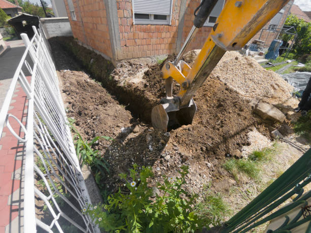 istock Earth mover digging trench in backyard ground 960334286
