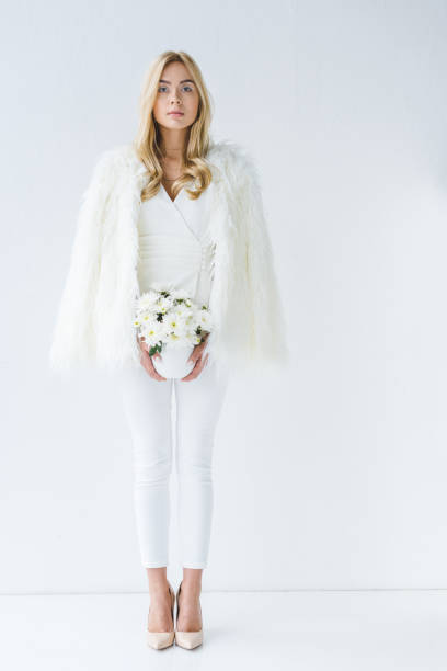 istock woman in fur coat with white flowers 960337048