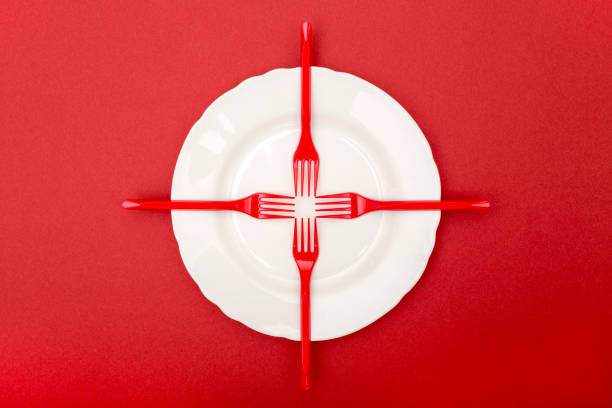 istock Still Life with plastic forks and a plate on a red background 960340570