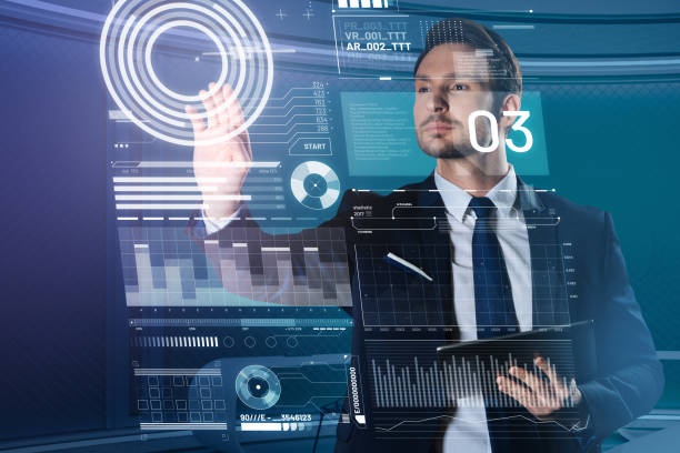 istock Handsome man in a suit touching the transparent screen and looking calm 960348016